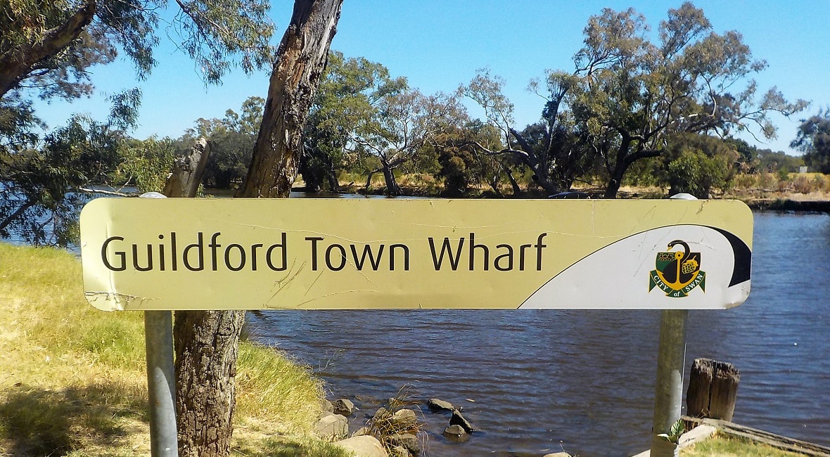 Guildford Town Wharf sign by the river near the bridge